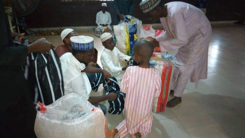 Community members receiving prepared food parcels.